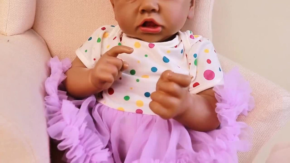 Reborn Baby Doll 21.5-Inch Full Vinyl Design with Curly Dark Hair, Open Eyes and Purple-and-White Outfit — image 7