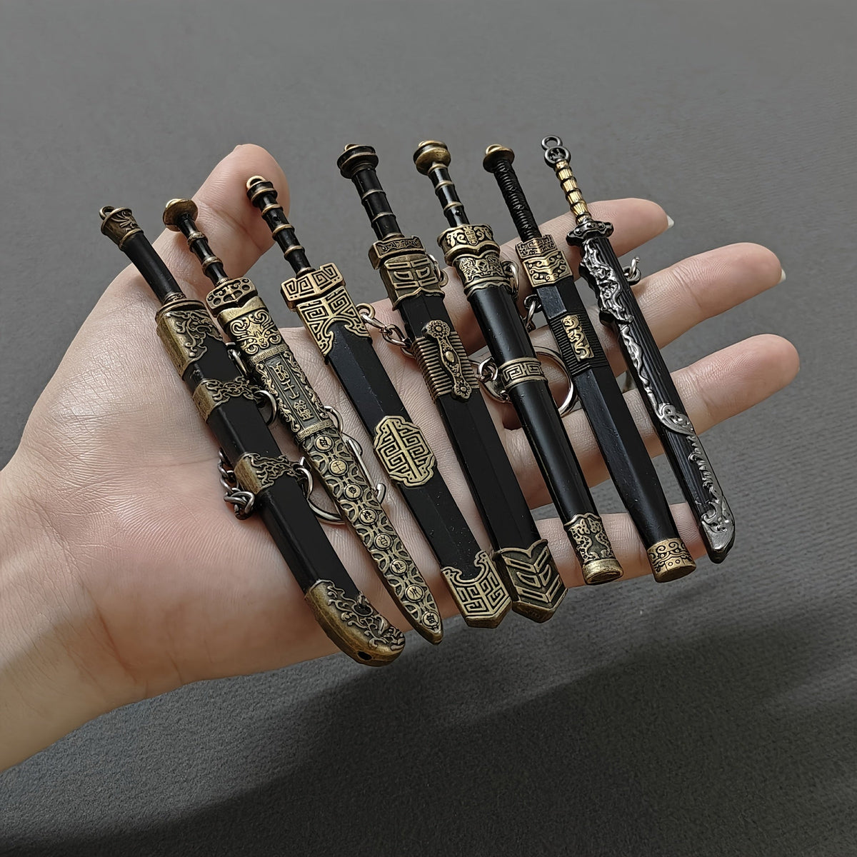 Seven-Piece Miniature Metal Sword Replica Set with Sheaths, Keychains and Ancient-Inspired Display Designs — image 11